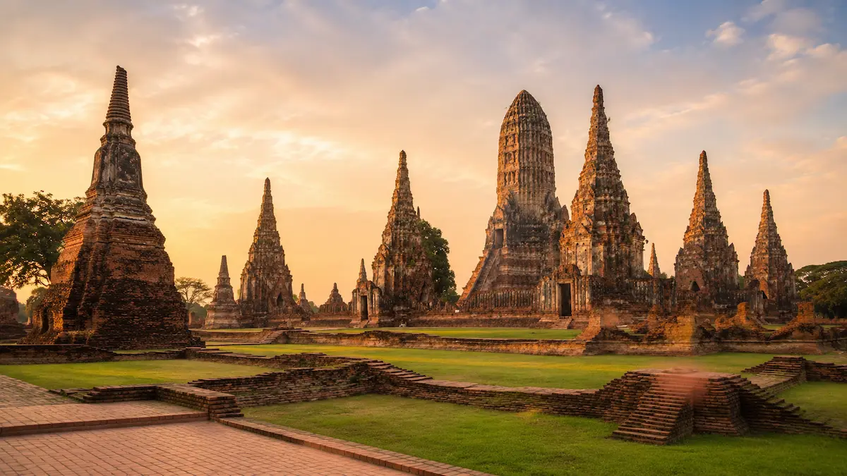 Ancient brick temples and chedis in Ayutthaya Historical Park at sunset