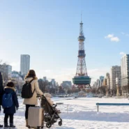 Family choosing a child-friendly hotel near Sapporo Station in winter