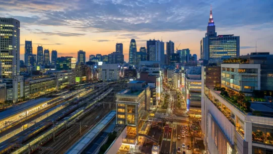 Traveler with luggage comparing the best hotels near Shinjuku Station in Tokyo
