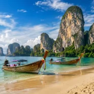 Krabi limestone islands and longtail boat in calm tropical sea