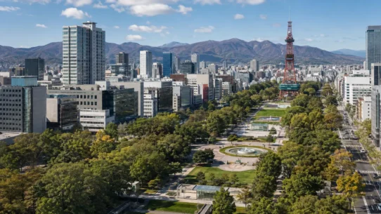 Seasonal views of Sapporo showing cherry blossoms, green summer parks, autumn foliage and winter snow