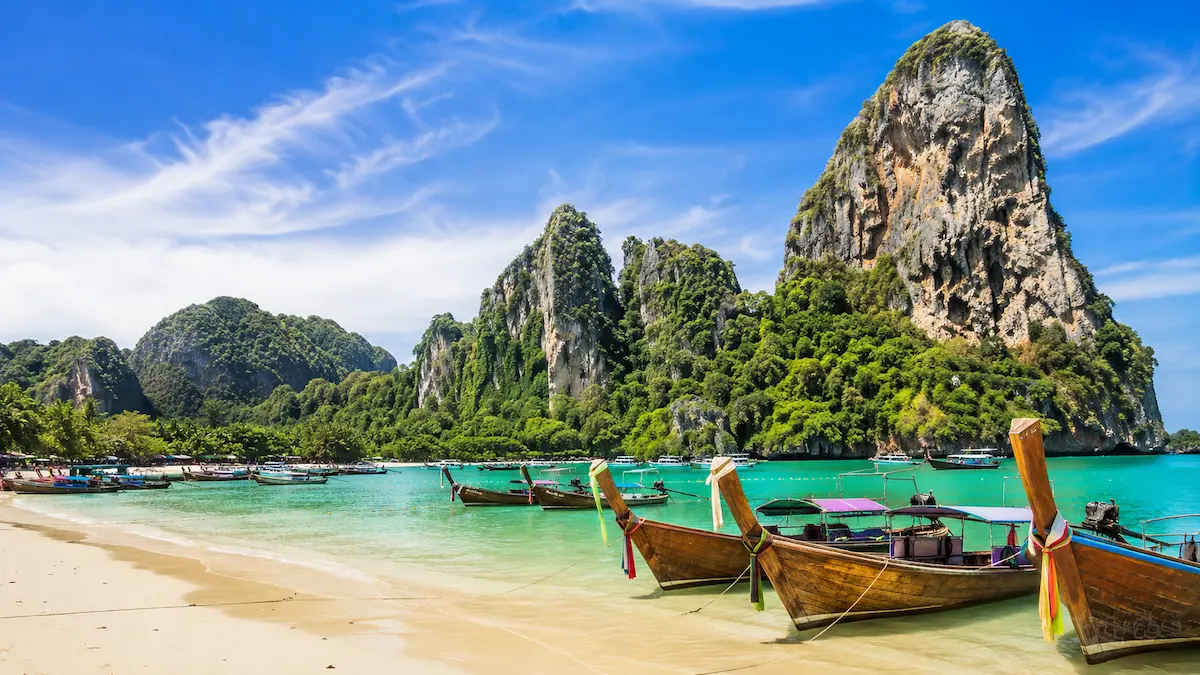 Krabi limestone cliffs, turquoise sea and longtail boats for a first-time travel guide