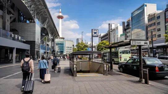 Traveler comparing transport from Kyoto Station to Kyoto city center