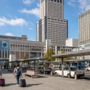 Traveler choosing between walking, subway and taxi from Sapporo Station to Odori and Susukino