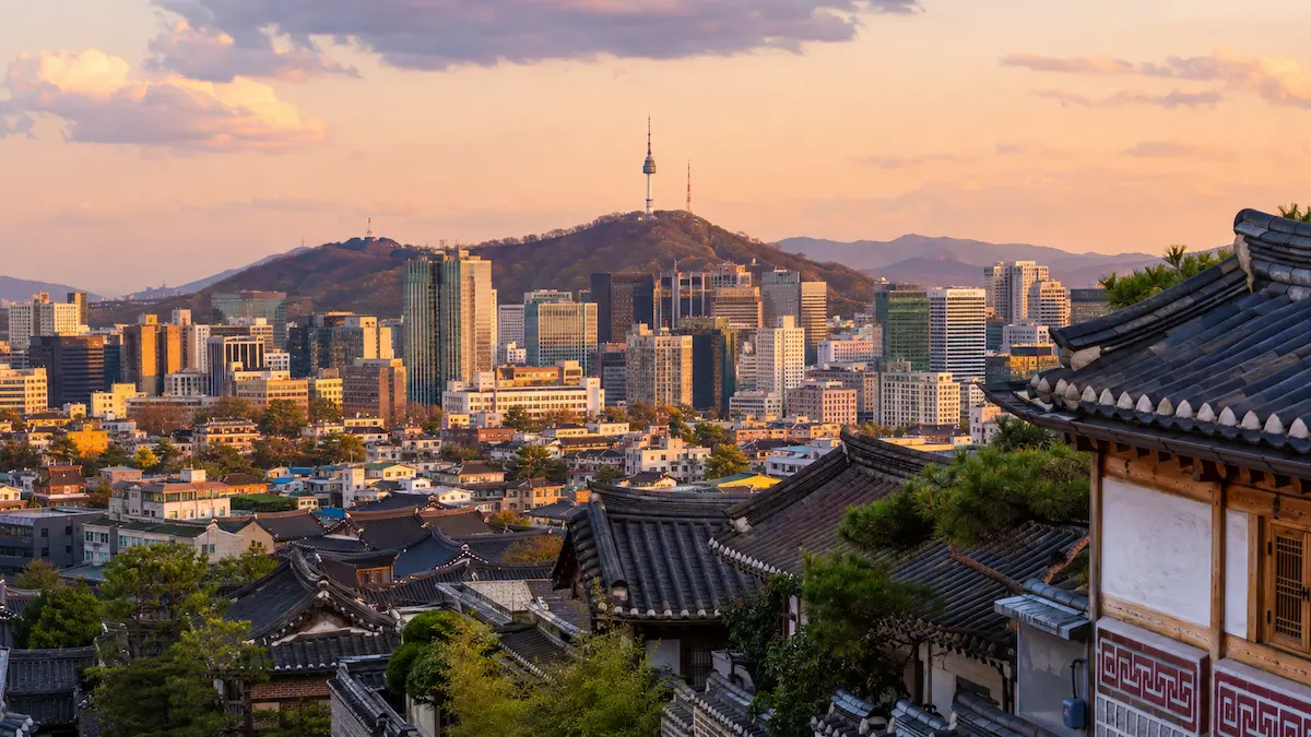 Gyeongbokgung Palace and the modern Seoul skyline for a first-time Seoul travel guide